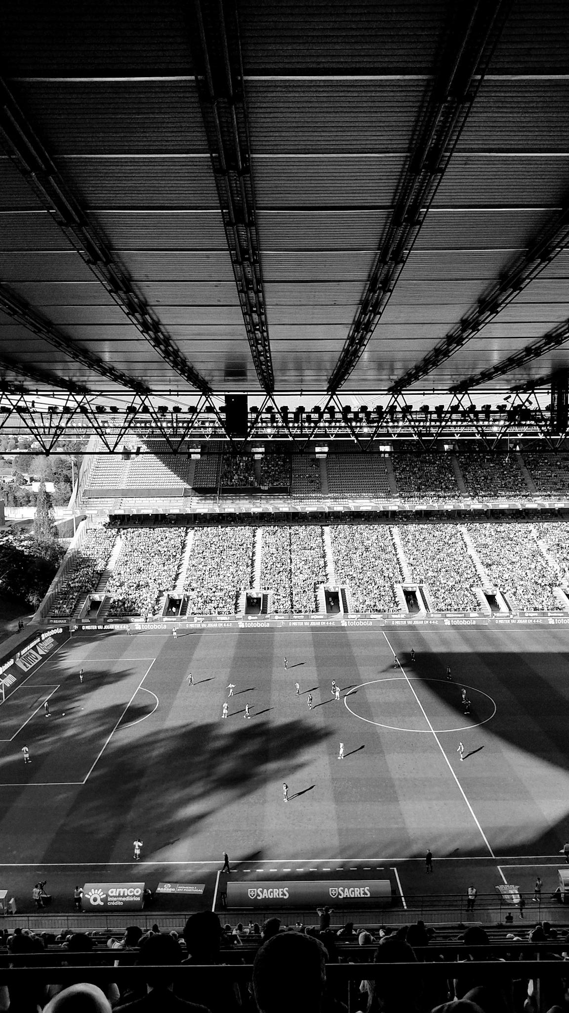 A striking black and white aerial view of a football match at a stadium in Braga, Portugal.